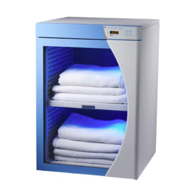 A blue and grey blanket warmer cabinet warms two shelves of blankets for patients.