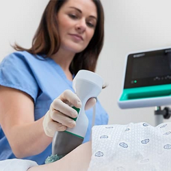 Image of An ultrasound technician conducts a scan on a patient.